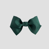 Forest green hair bow on a white background