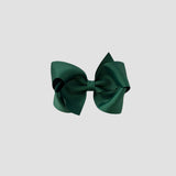Forest green hair bow on a white background