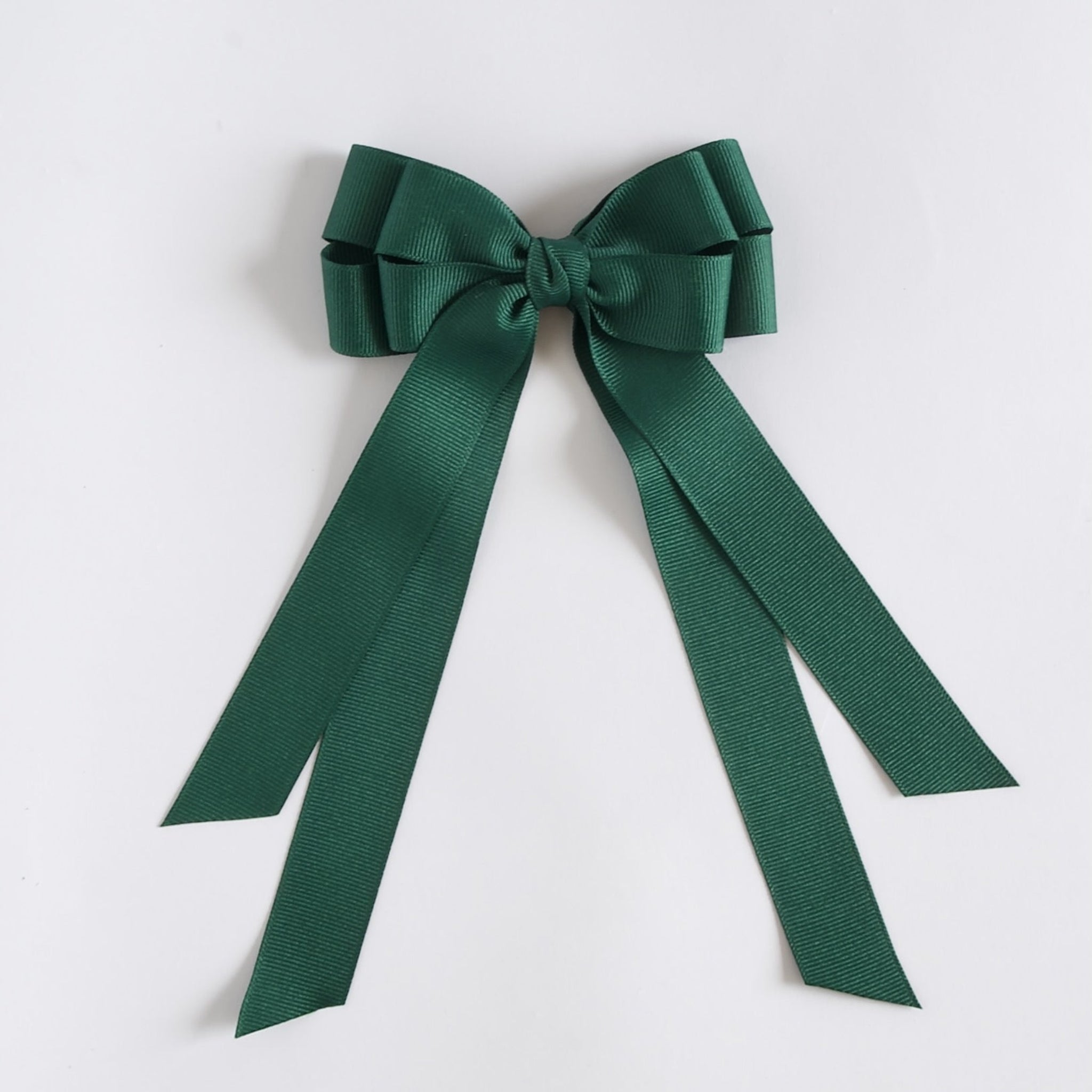 Forest green ribbon bow on a white background