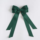 Forest green ribbon bow on a white background