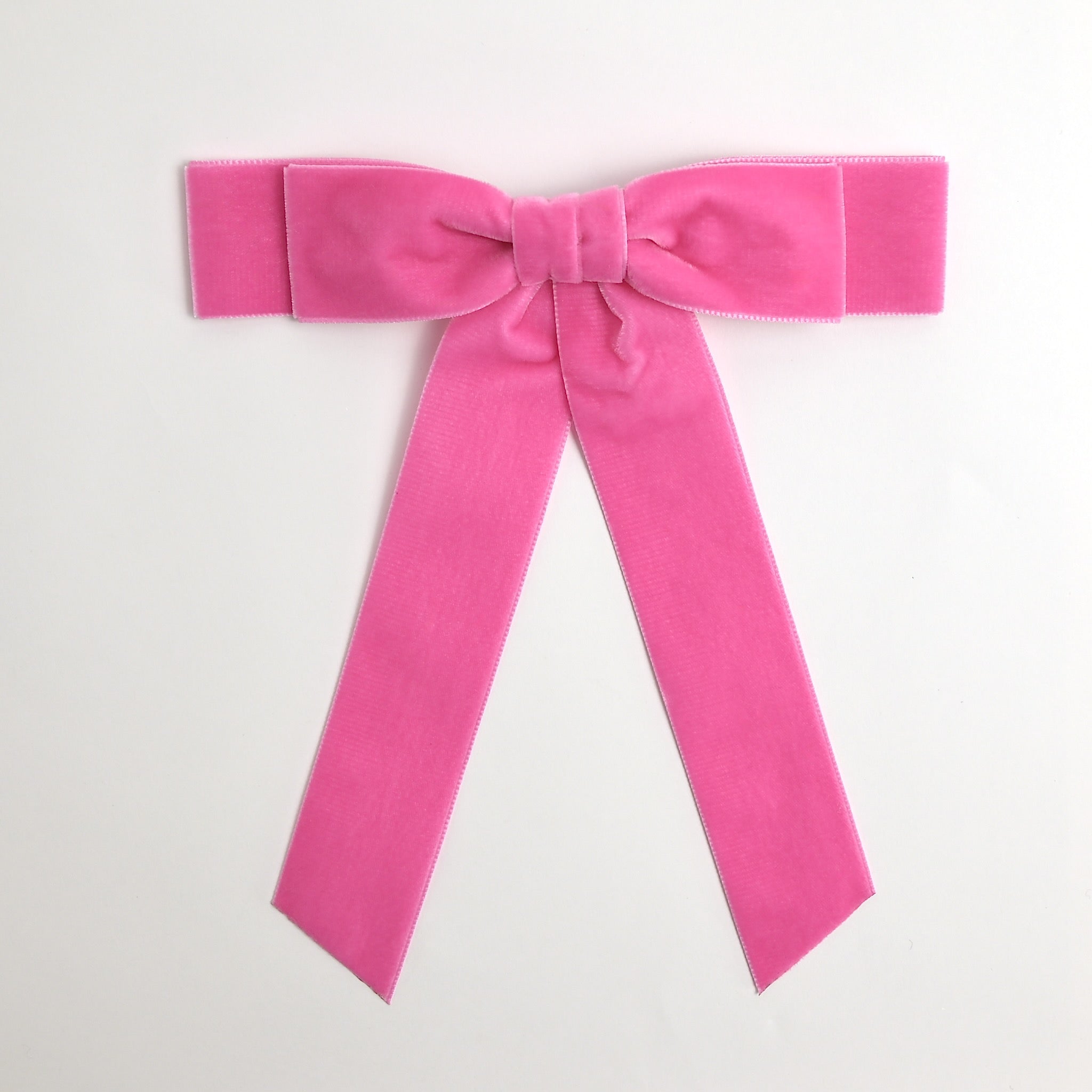 Hot pink Grace velvet hair bow for women. Double bow with long tails on white background 