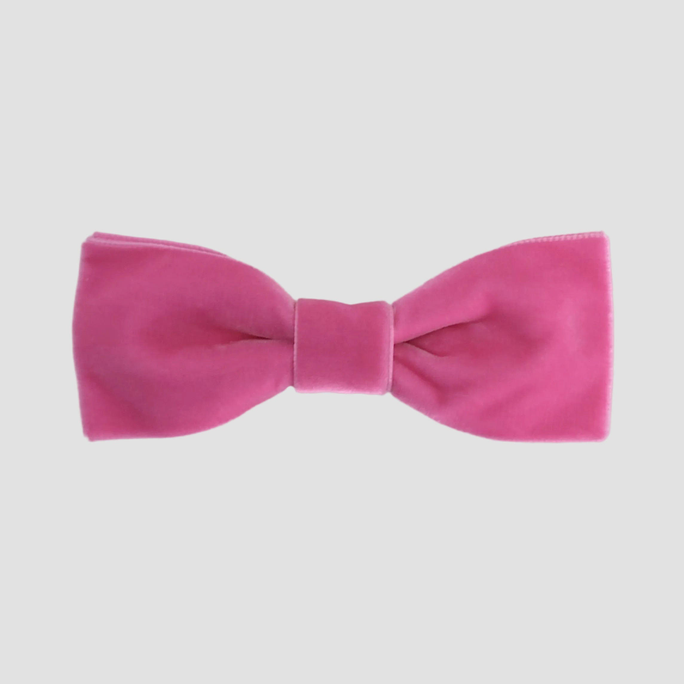 Hot pink men bow tie on a white background.