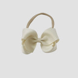 Ivory bow on a nude nylon headband