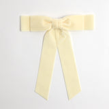 Ivory Grace velvet hair bow for women. Double bow with long tails on white background 
