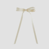 Ivory-colored ribbon bow on a white background