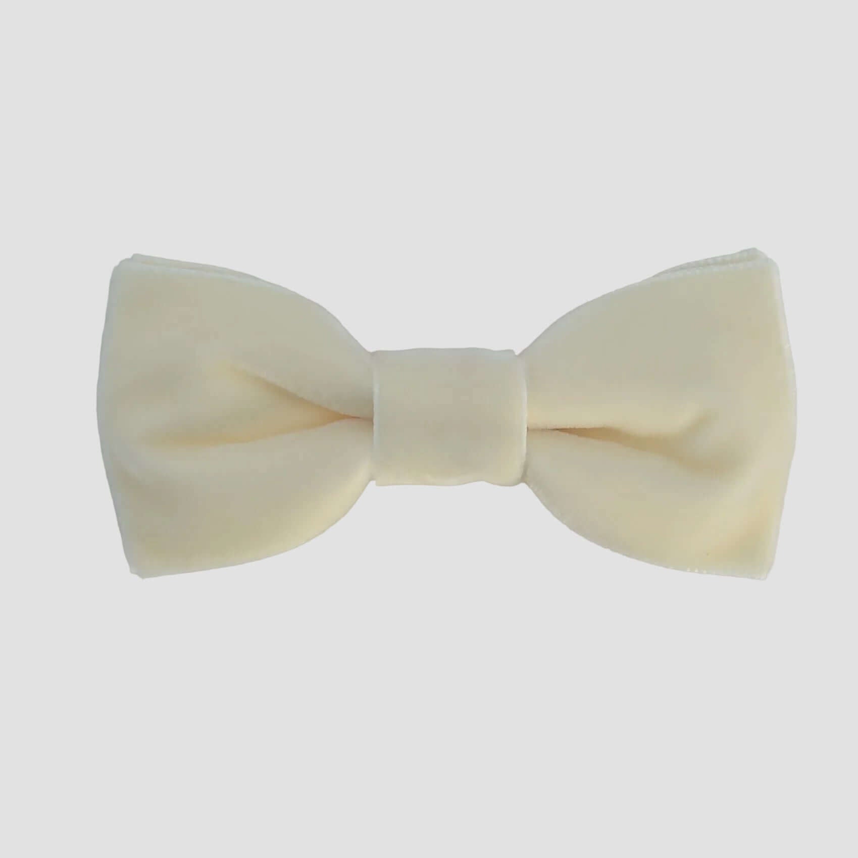 Ivory velvet bow tie on a white background