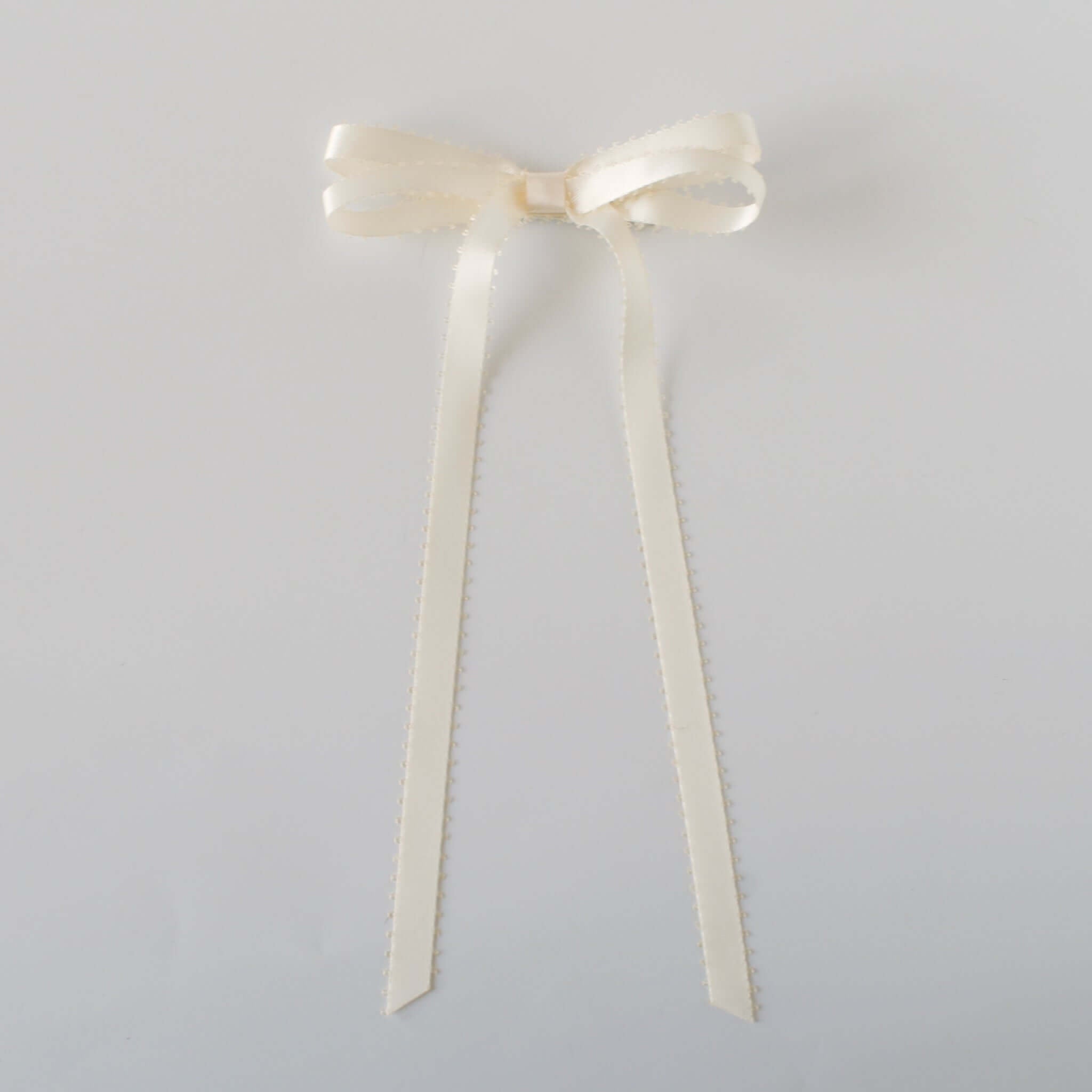 Olivia Picot Satin Bow in ivory, featuring charming picot edges and smooth satin ribbon, perfect for hairstyles.