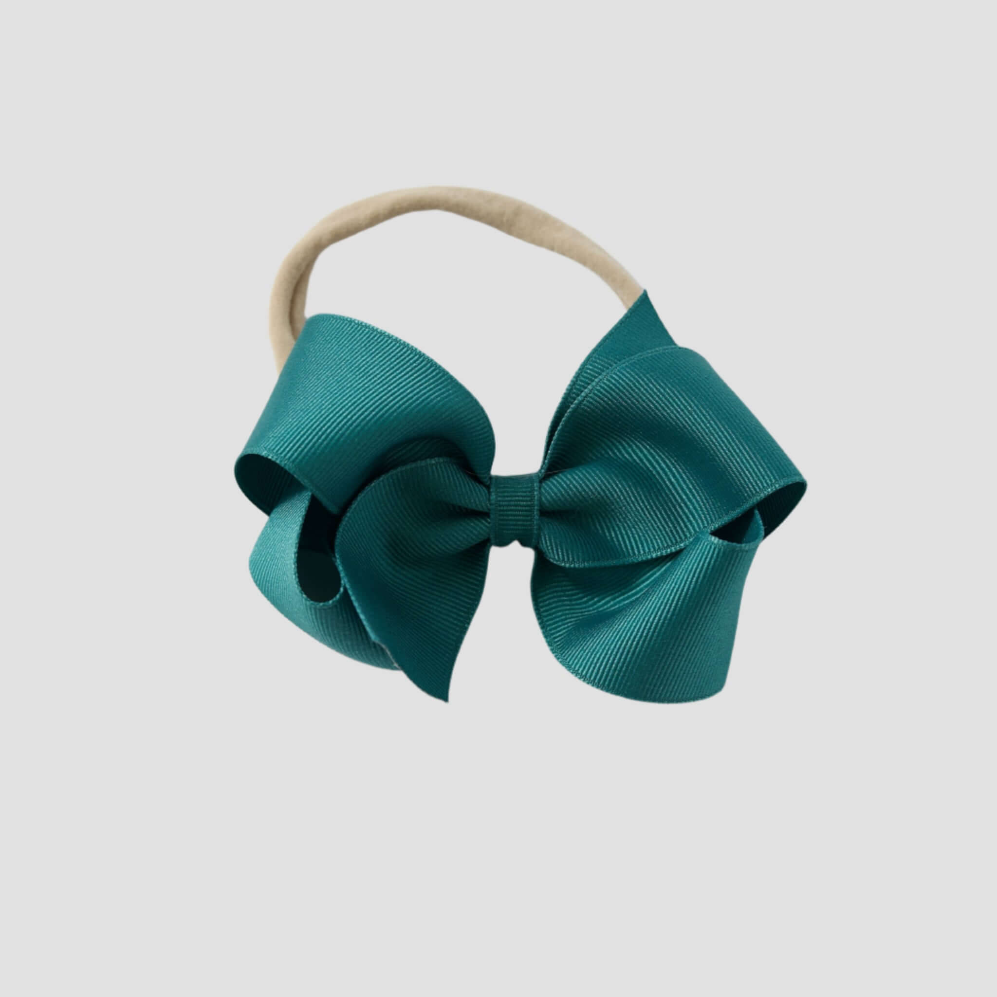Jade blue bow on a nude nylon headband