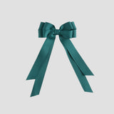 Jade bow with long ribbons on a white background