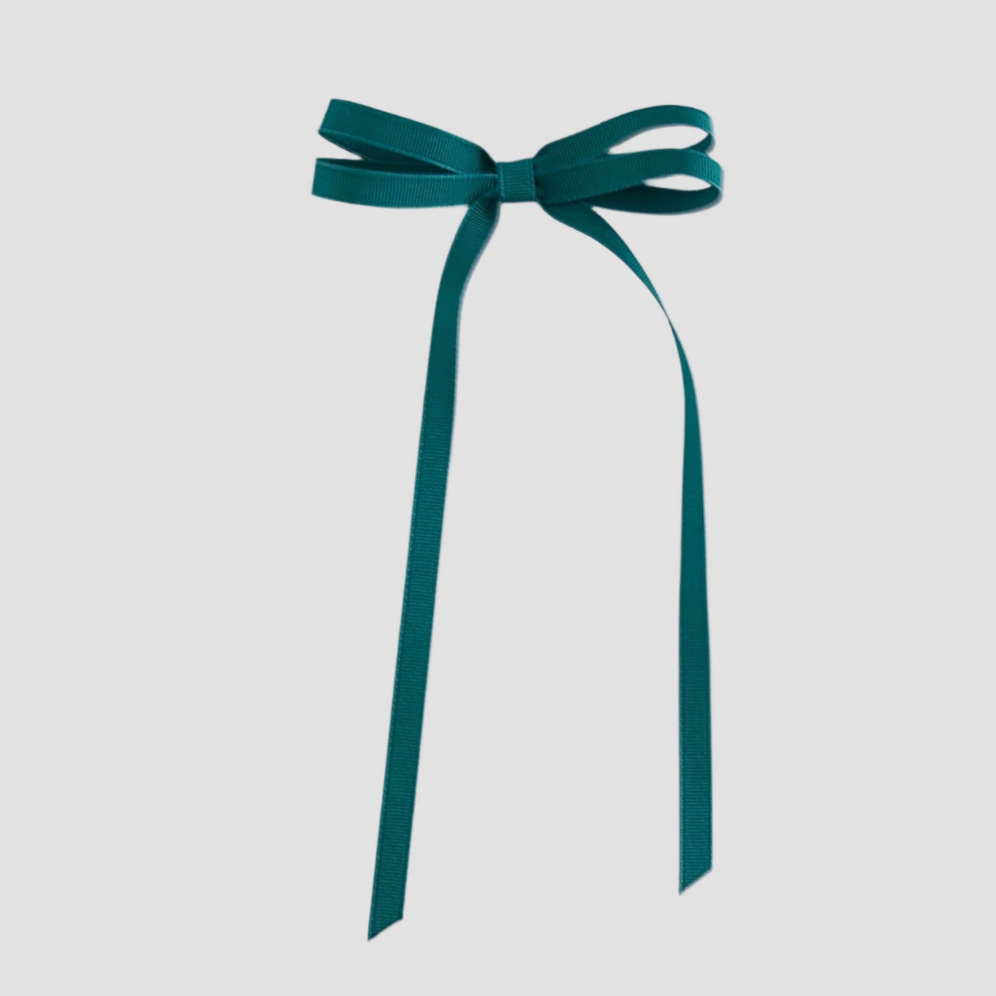 Jade green ribbon bow on a white background