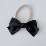 Sustainable recycled polyester matte satin bow headband for newborns to toddlers in black