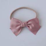 Sustainable recycled polyester matte satin bow headband for newborns to toddlers in dusty rose