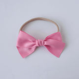 Sustainable recycled polyester matte satin bow headband for newborns to toddlers in pink