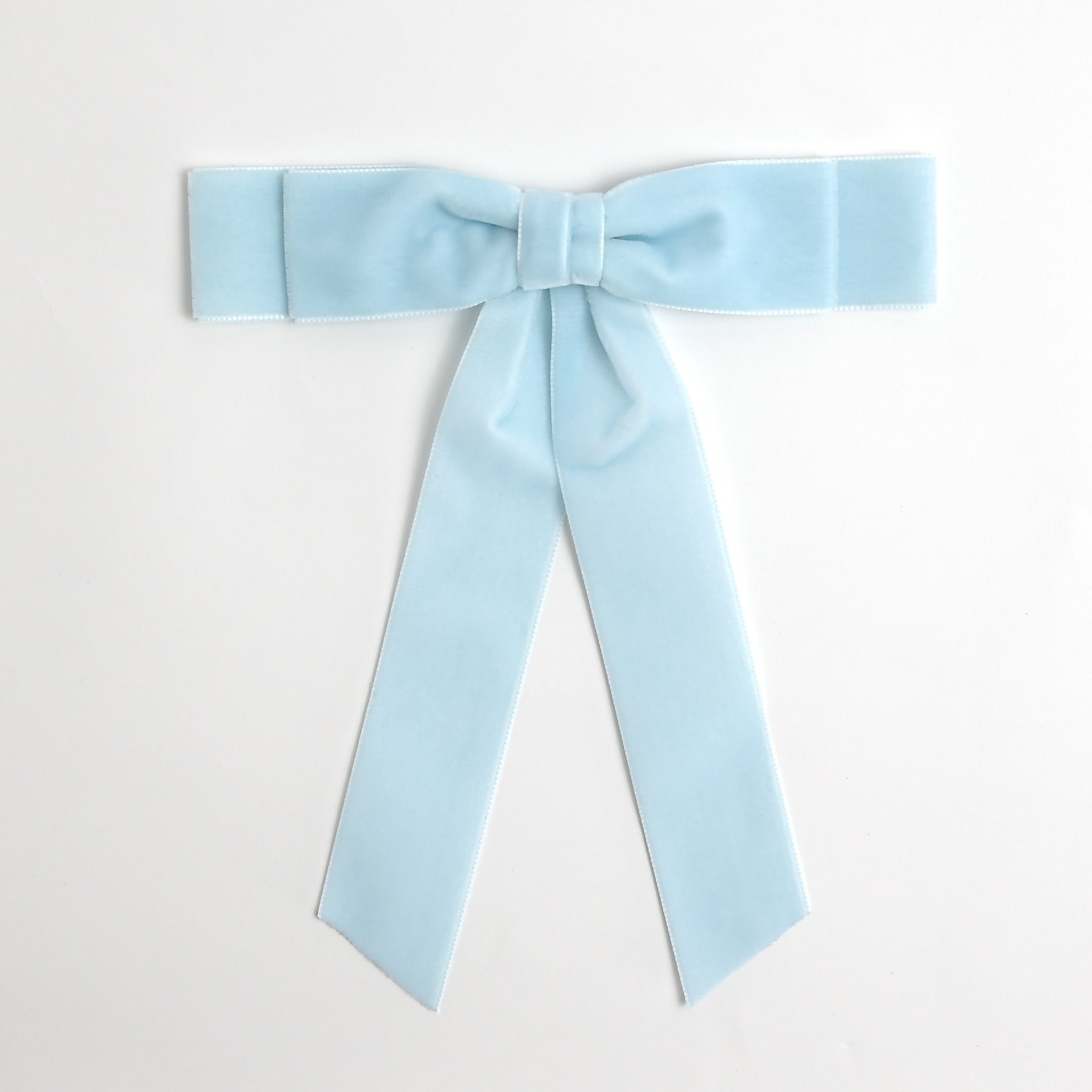 Light blue Grace velvet hair bow for women. Double bow with long tails on white background 