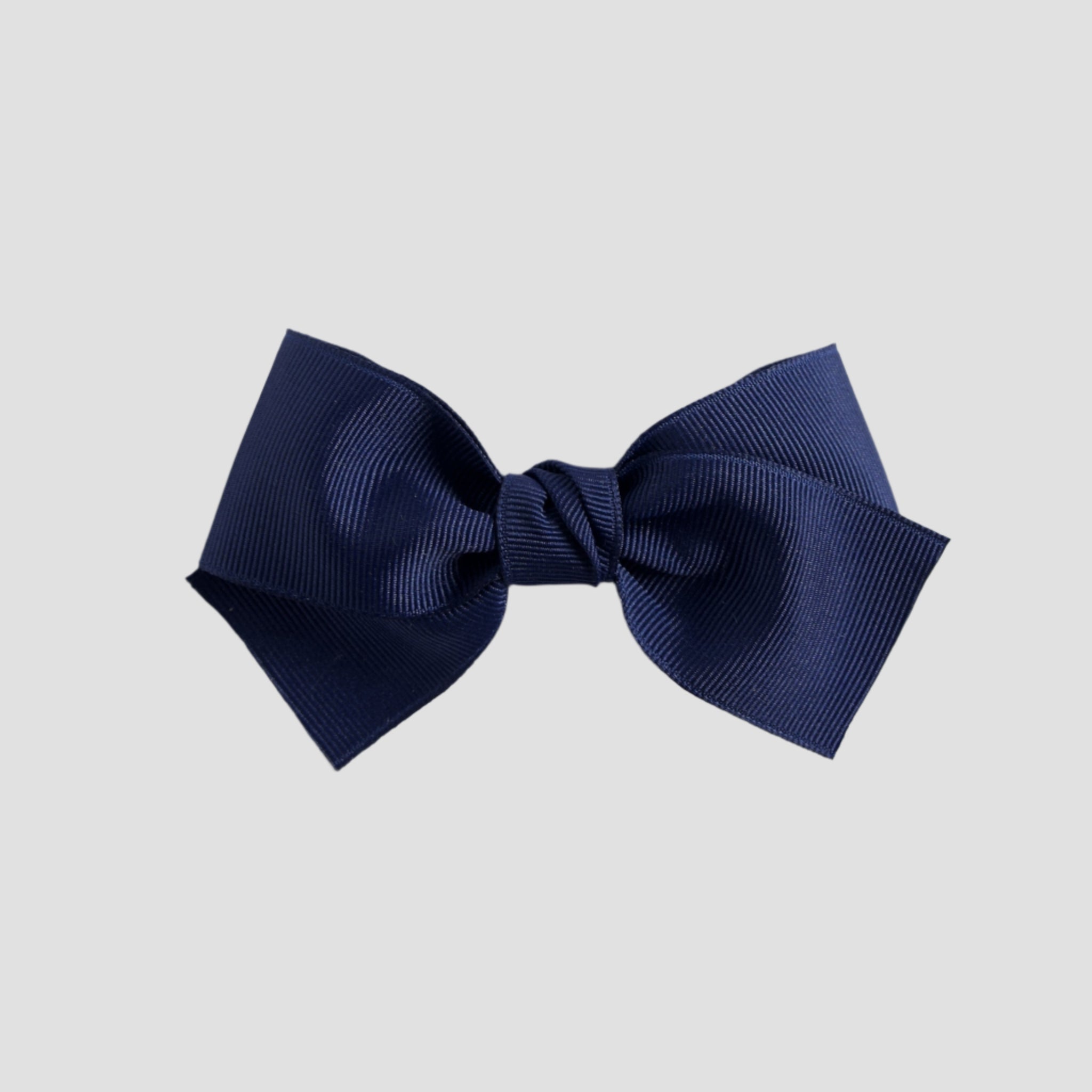 Light navy blue bow on a white background