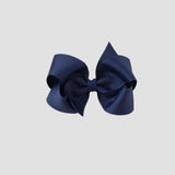 Light navy blue hair bow on a white background