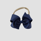Light navy blue bow on a nude nylon headband