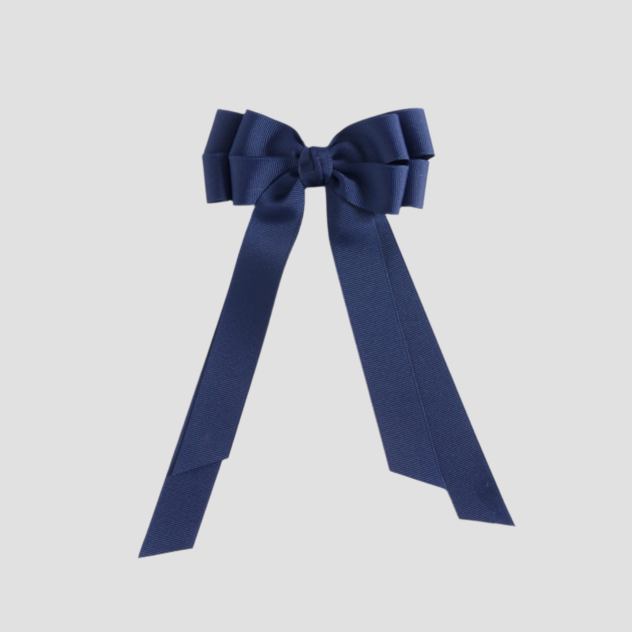 Light navy blue bow on a white background