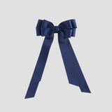 Light navy blue bow on a white background
