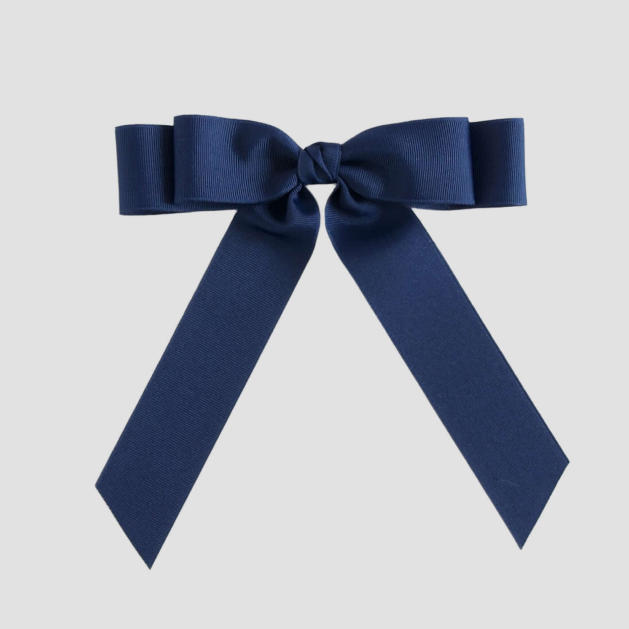 Light navy blue bow on a white background