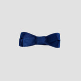 Light navy blue bow on a white  background