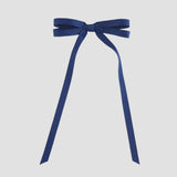 Light navy blue ribbon bow on a white background