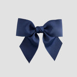 Light navy blue bow on a white background