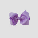 Light orchid purple hair bow on a white background