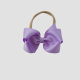 Light orchid purple bow on a nude nylon headband