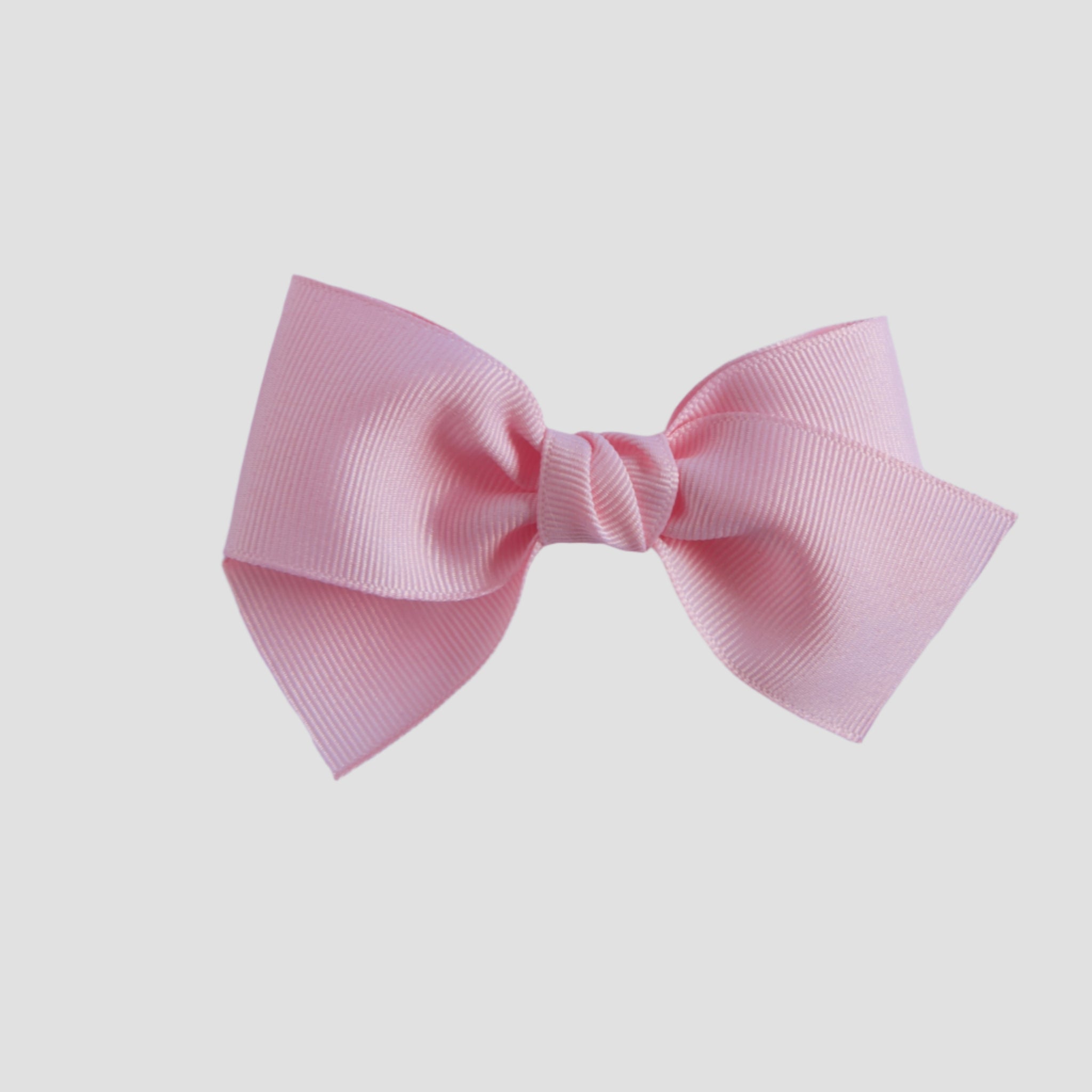Light pink hair bow on a white background