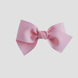 Light pink hair bow on a white background