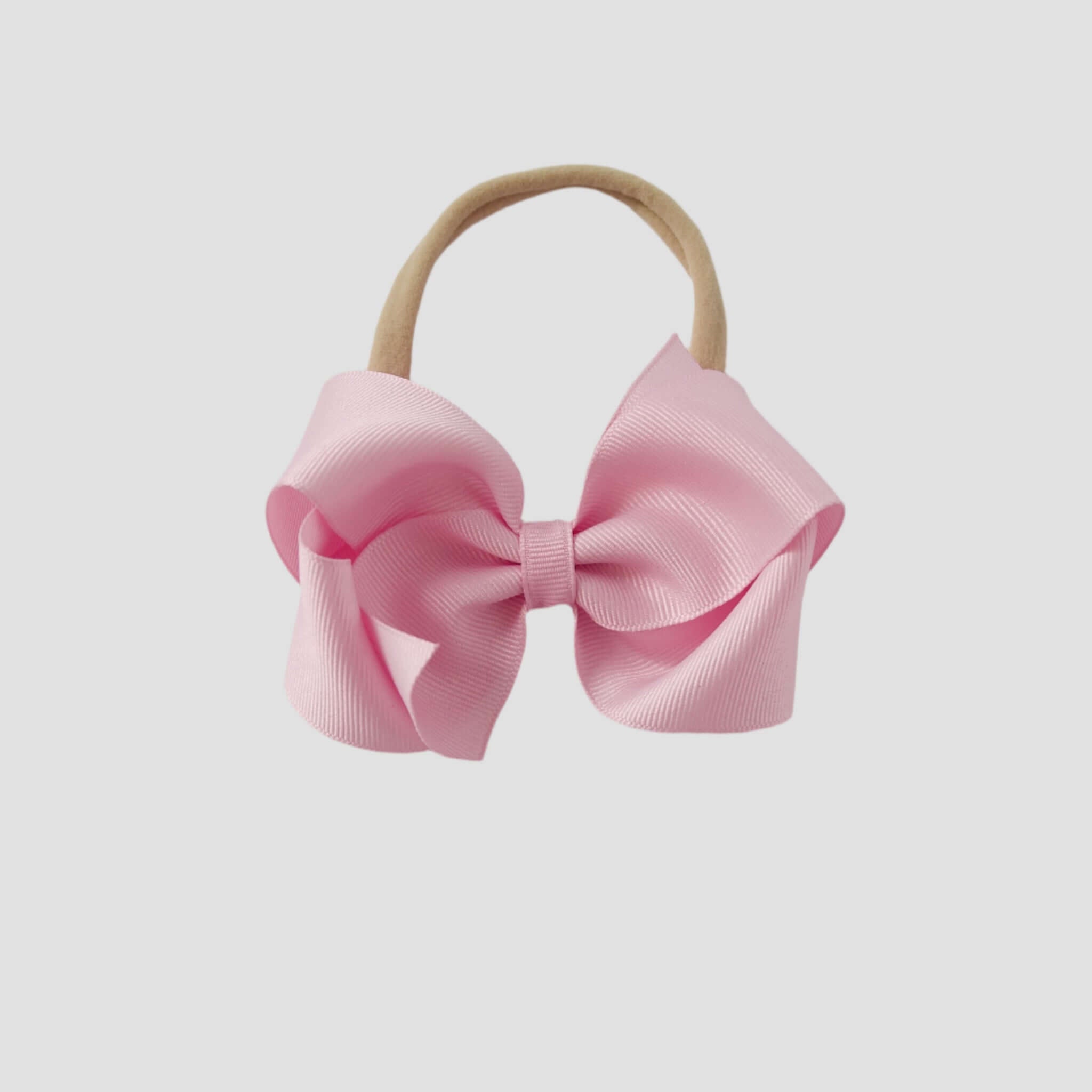 Light pink bow on a nude nylon headband
