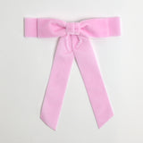 Light pink Grace velvet hair bow for women. Double bow with long tails on white background 