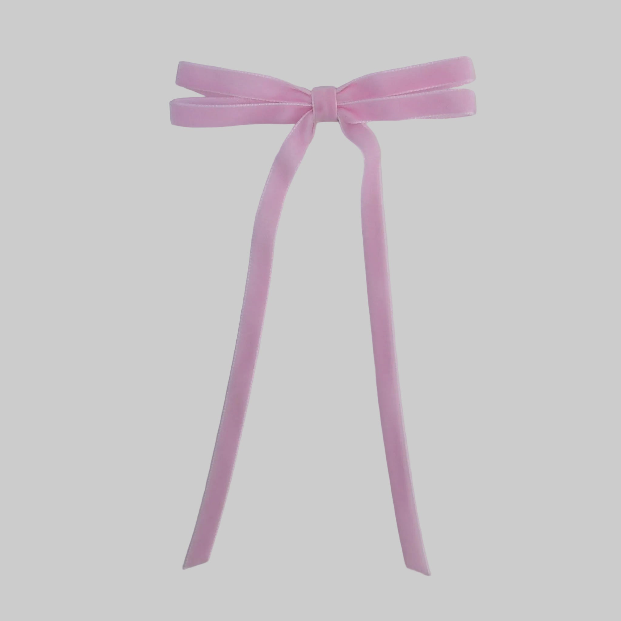 Light pink Olivia velvet hair bow for women with long tails on white background