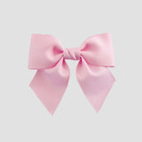 Light pink bow on a white background