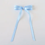 Olivia Picot Satin Bow in light blue, handcrafted with picot edges for chic hairstyles, suitable for women and girls.