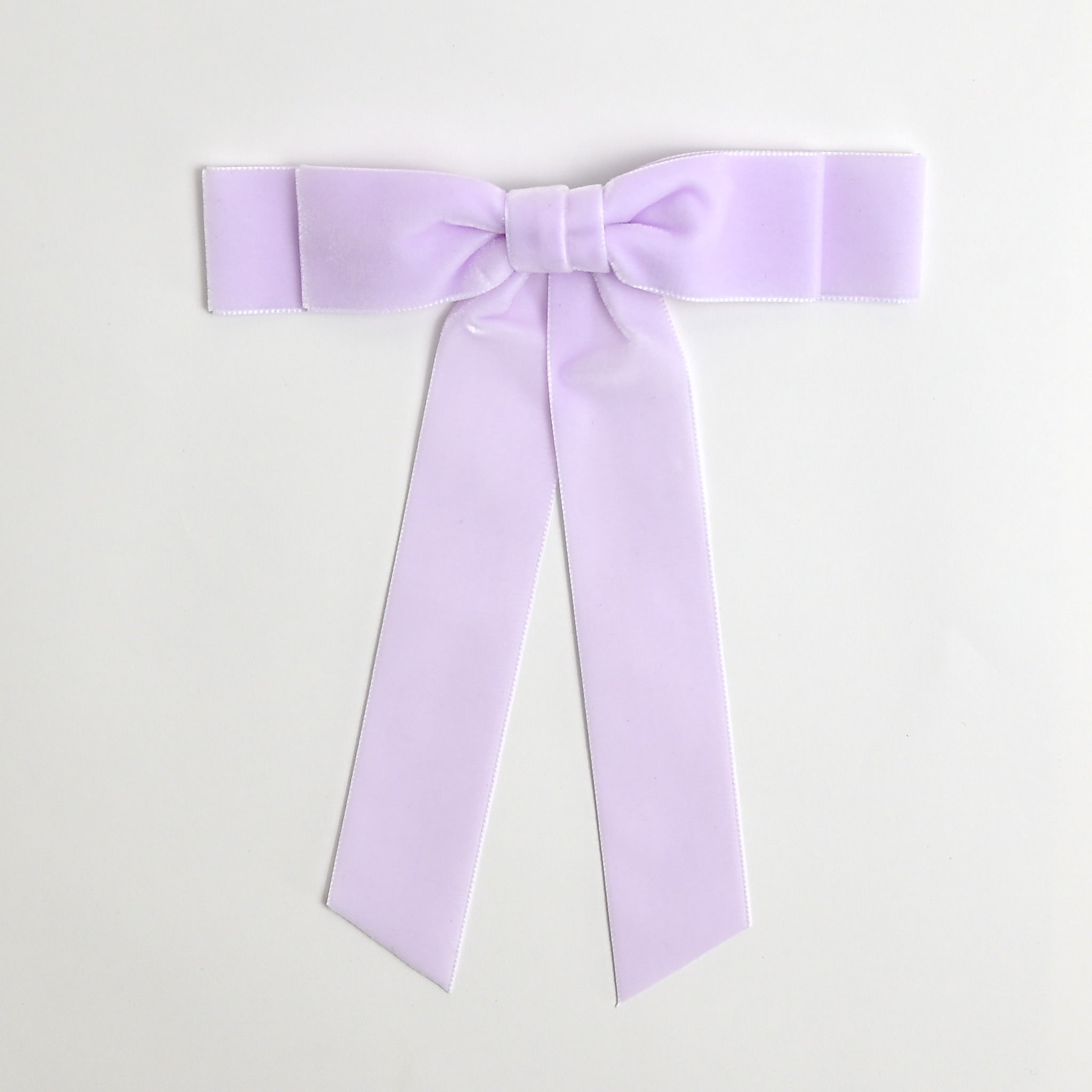 Lilac Grace velvet hair bow for women. Double bow with long tails on white background 