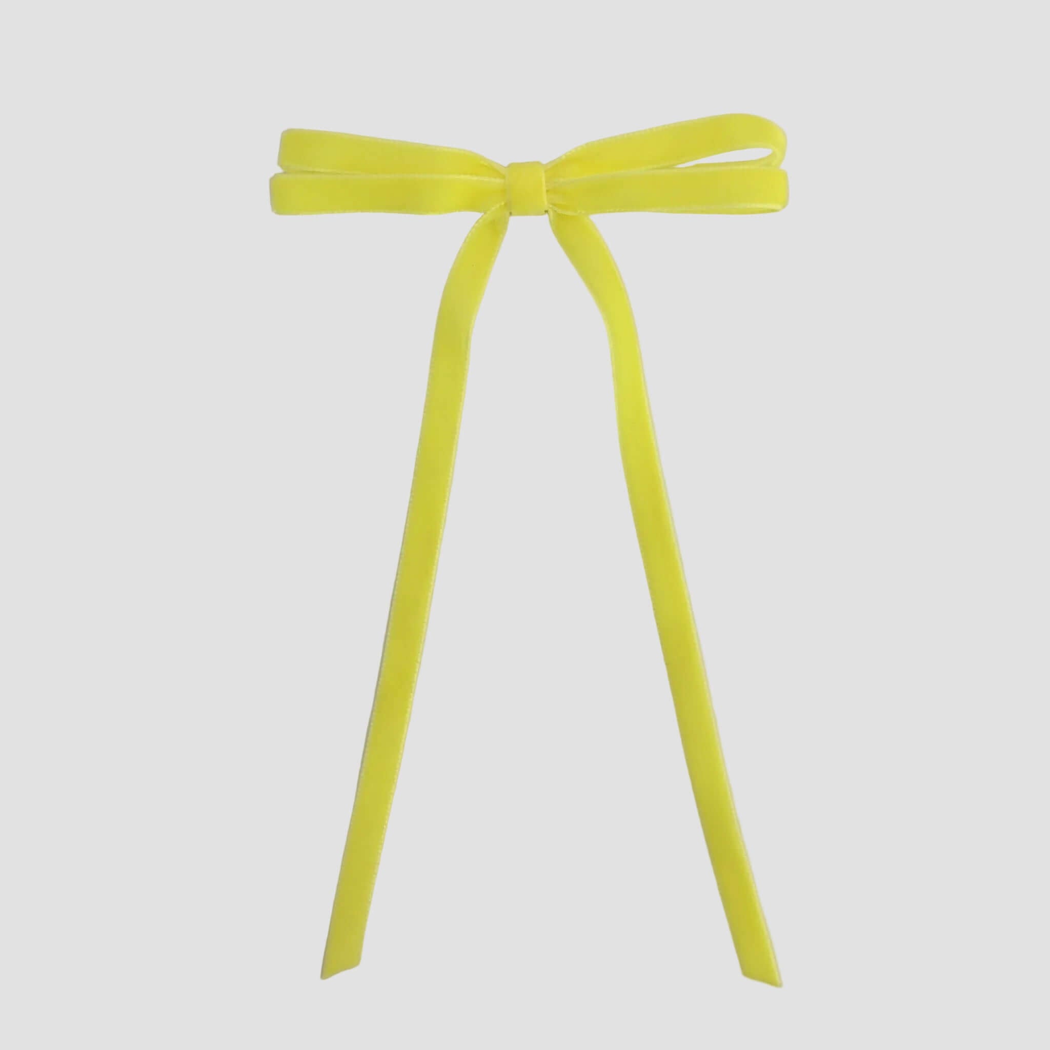 Light yellow Olivia velvet hair bow for women with long tails on white background