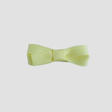 Maize yellow bow on a white background