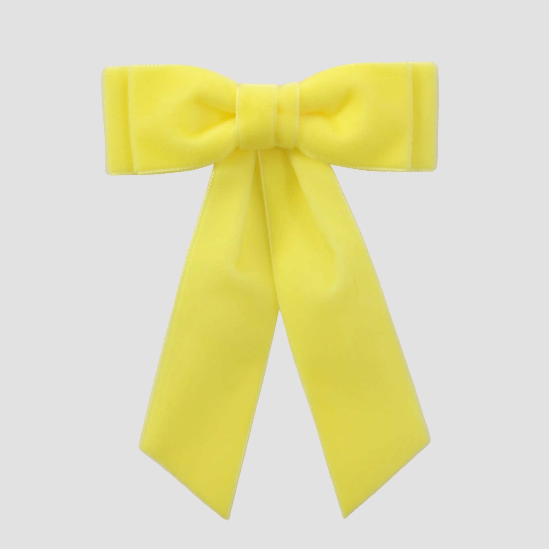 Maize yellow velvet Mia bow on a white background