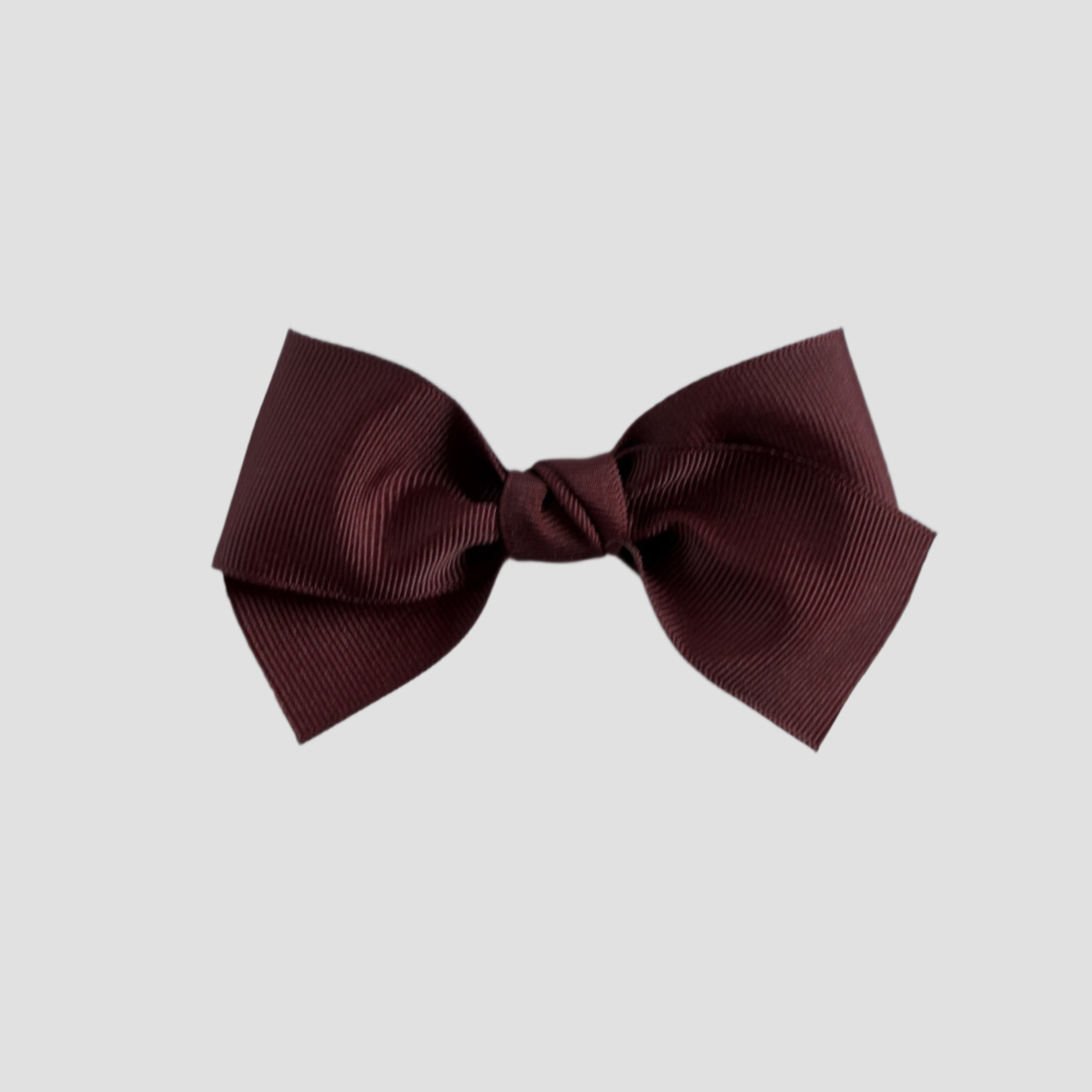 Maroon hair bow on a white background