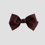 Maroon hair bow on a white background