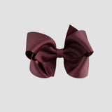 Maroon hair bow on a white background