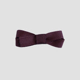 Maroon bow on a white background