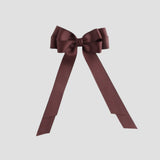 Maroon bow with long tails on a white background