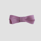 Mauve pink bow on a white background