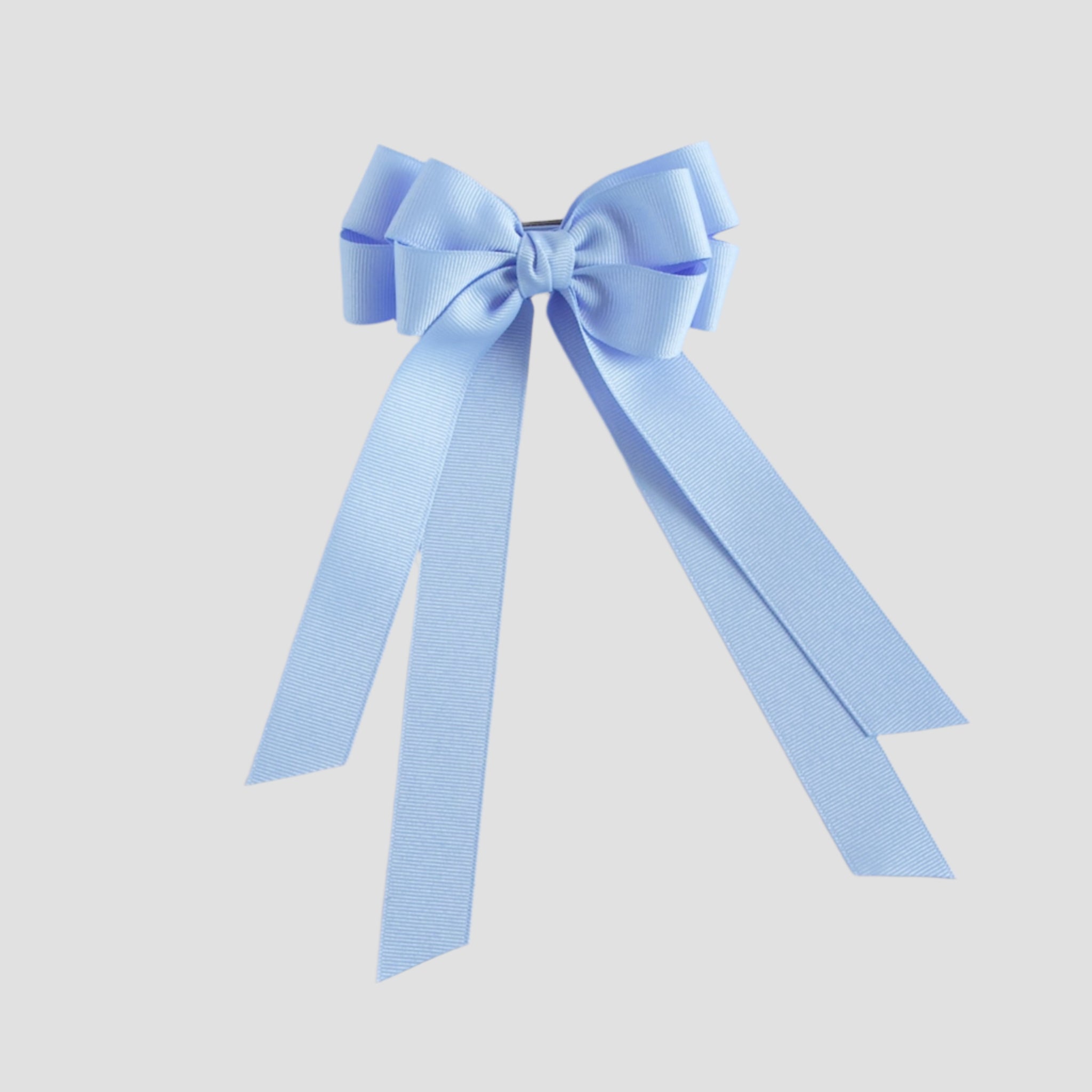 Blue bow with long tails on a white background