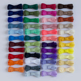 Collection of colorful bow hair clips on a white background