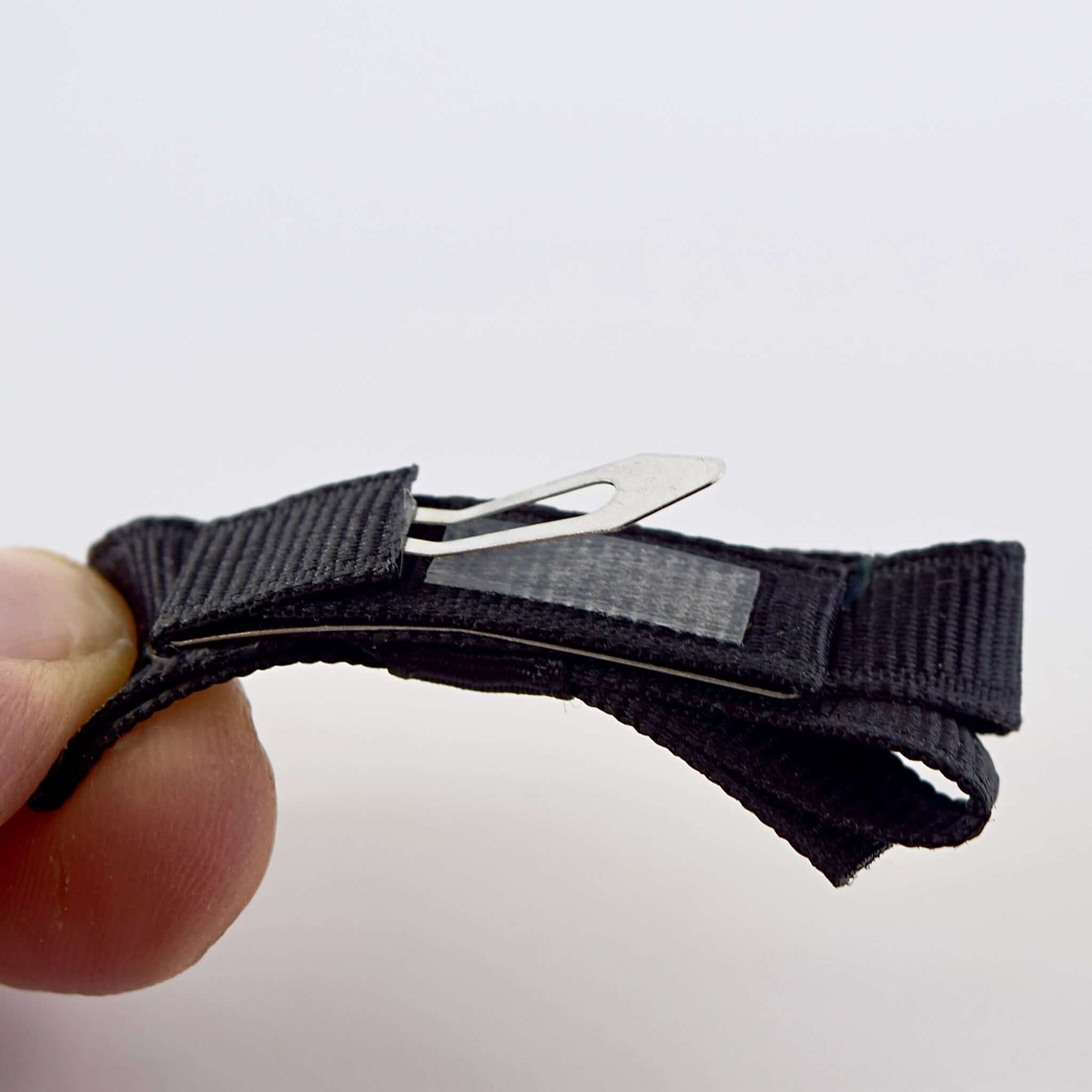 Close-up of a black grosgrain ribbon hair bow with a snap clip and no-slip grip.