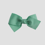 Mint green bow on a white background